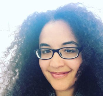 Girl with curly hair wearing glasses