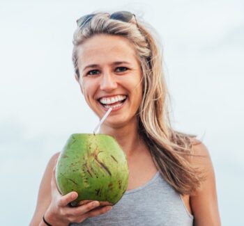 blonde girl drinking coconut juice