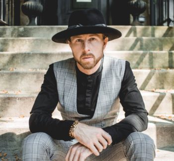 dapper guy sitting on stairs