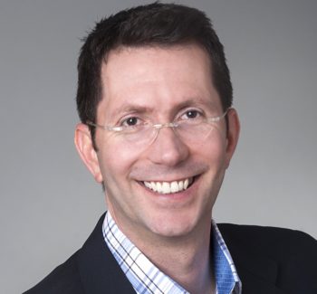 professional headshot of a guy with glasses