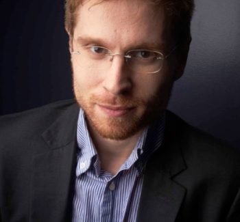 man wearing a suit and eyeglasses