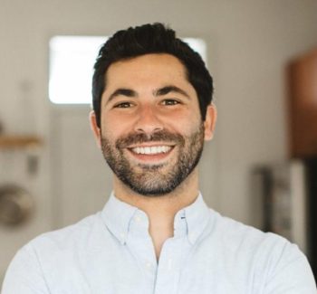 man with a beard wearing white button down shirt