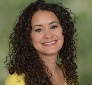 headshot of a woman with curly hair
