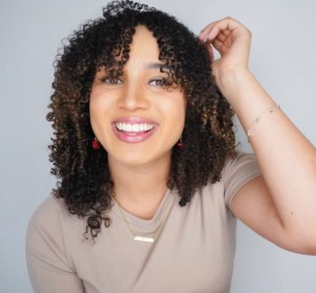 headshot of a woman with curly brown hair