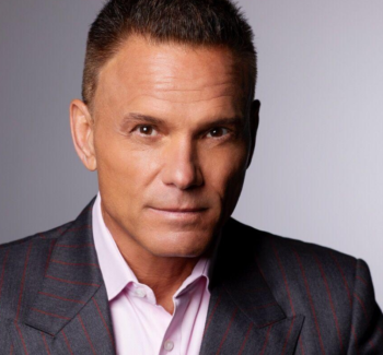 headshot of a man in gray suit