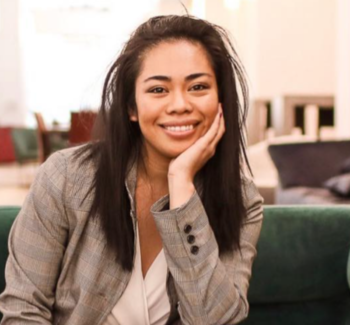 headshot of a woman wearing gray blazer