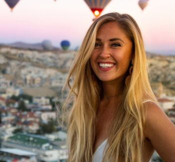 woman with hot air balloons at the background