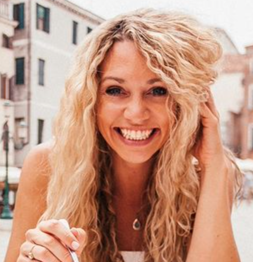 headshot photo of a blonde woman smiling