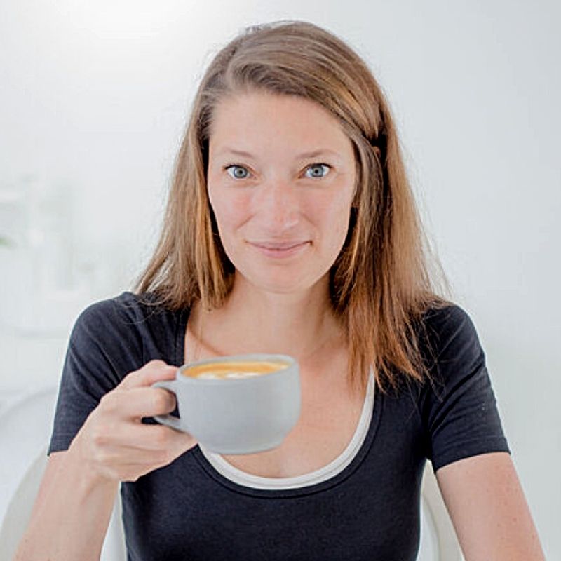 red-haired woman holding a cup of coffee