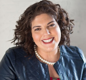 woman smiling wearing pearl necklace