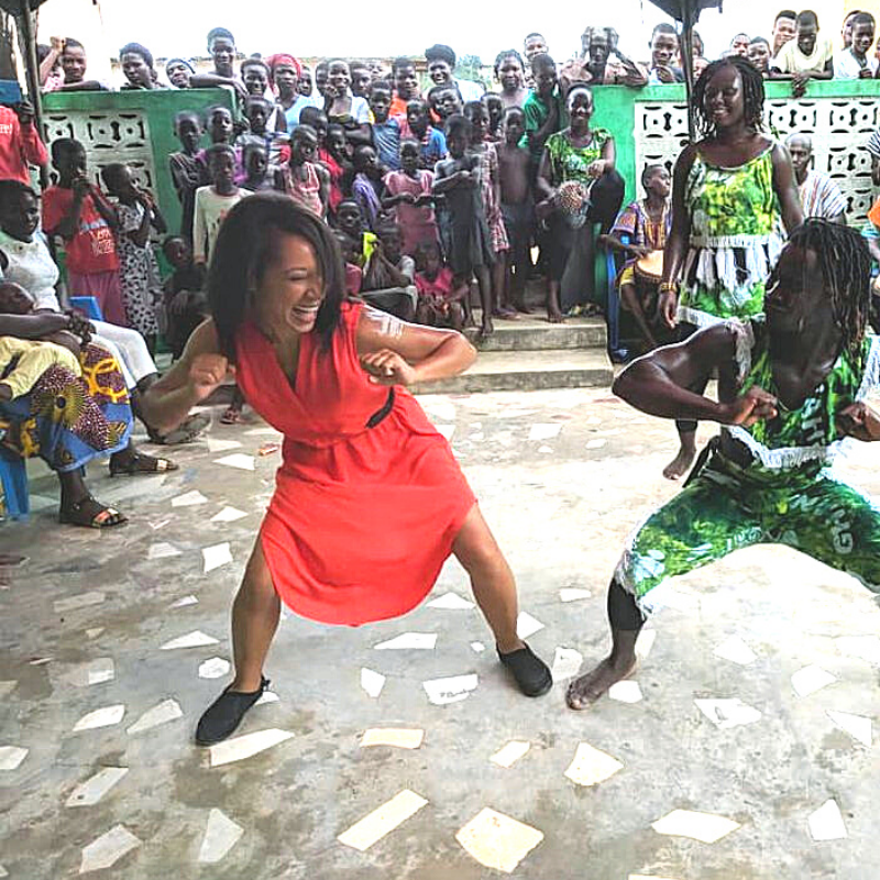 woman dancing beside a man with happy onlookers