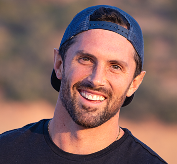 headshot photo of a man wearing cap