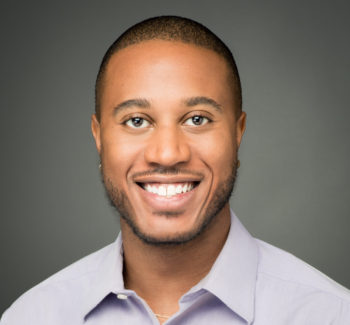 headshot photo of a man smiling