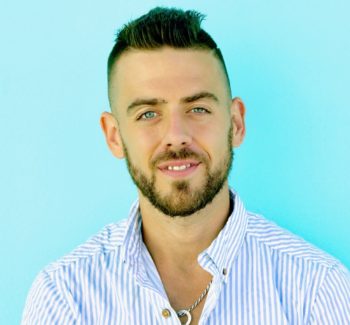 headshot photo of a man in aqua green background