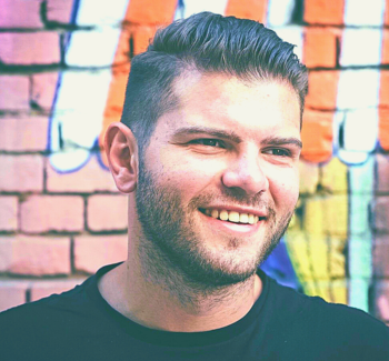 headshot photo of a man smiling