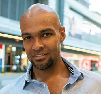 headshot photo of a man smiling