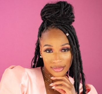 headshot photo of a woman with a pink background