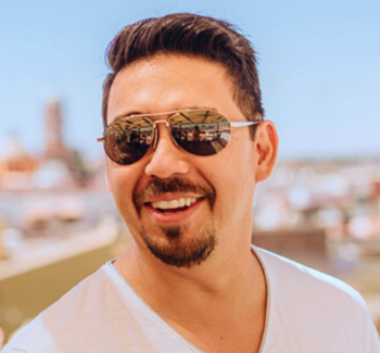 headshot photo of a man wearing sunglasses