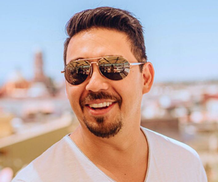 headshot photo of a man wearing sunglasses