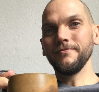 man holding a coffee cup