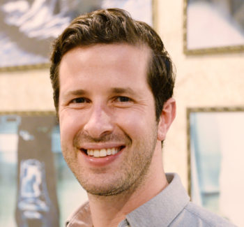 headshot photo of a man smiling