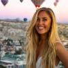 woman with hot air balloons at the background